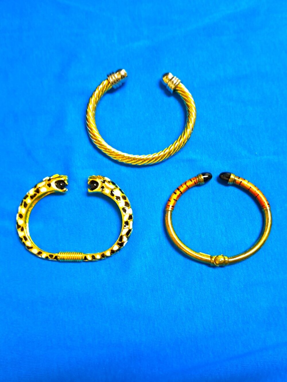 3 LADIES BANGLE & SPRING BRACELETS 2 ANIMAL PRINT 1 WITH TWISTED DESIGN